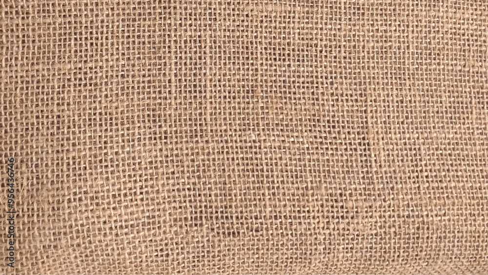 Detailed close-up of natural burlap fabric texture with woven pattern. Close-up shot to reveal texture of sack. Detailed close-up of natural burlap fabric texture with woven pattern. Close-up shot to reveal texture of sack.