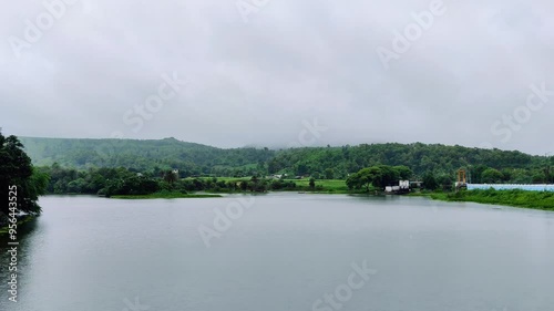 Time Lapse footage of landscape scene of a lake, hills, trees shot against a beautiful sunset. Scenic view from Mahi Dam at Banswara
 photo