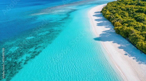 Aerial a pristine ocean coastline with crystal-clear turquoise waters lapping against white sandy beaches and a coral reef visible beneath the surface