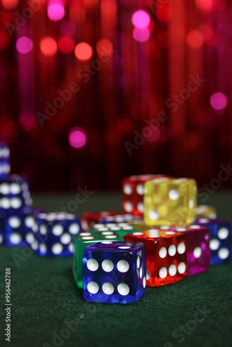 Canvas Print Stacks of Colorful Dice on Green Felt With Bokeh Background