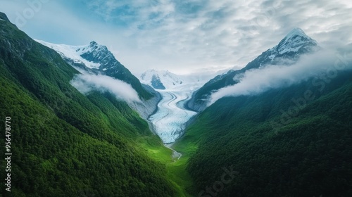 a majestic glacier slowly advancing through a valley, with crisp, icy details and the surrounding mountains shrouded in mist, an epic and dramatic natural landscape
