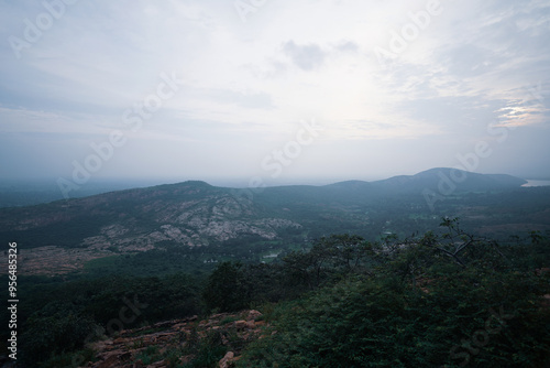 Aerial View of a Vast Landscape, Panoramic View of a Distant Valley, Scenic Landscape at Sunset Time, Misty Mountains and Rolling Hills Stock Photo.