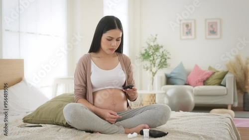 Pregnant woman checking blood sugar level by using Digital Glucose meter