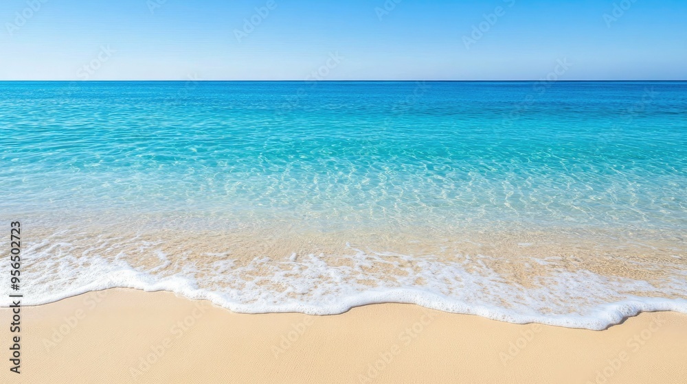 Fototapeta premium A serene beach scene with crystal clear turquoise water gently lapping at the soft, golden sand.