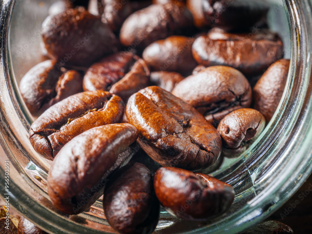 Close-up of roasted coffee beans poured out of a glass jar, Coffee beans spilled out from jar,Close up Close-up of roasted coffee beans poured out of a glass jar, Coffee beans spilled out from jar,Close up