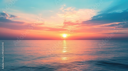 Stunning sunset over the ocean with a vibrant pink and blue sky.