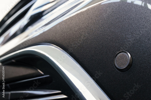 front parking sensor on a fender of modern car, proximity sensor to alert the driver of obstacles while parking, sensor on front bumper