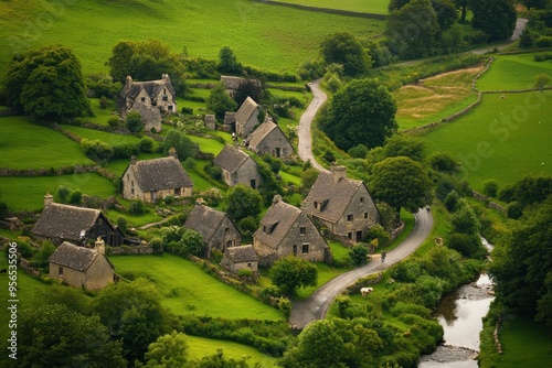 Aerial view of a quaint village surrounded by lush green fields and winding roads.