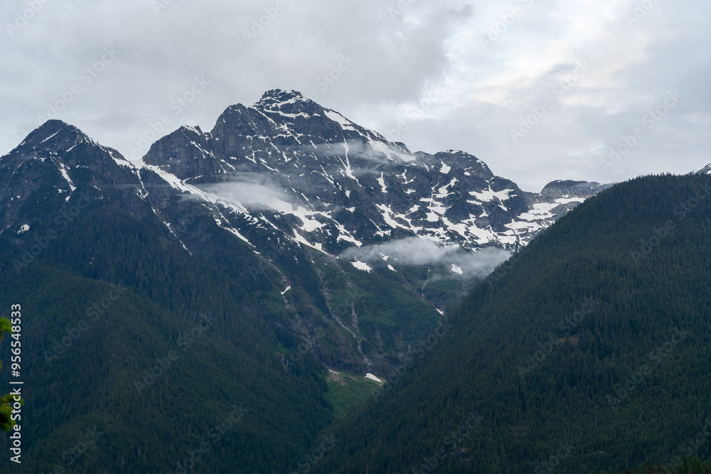 A stunning North Cascades mountain view on a cloudy day with a lot of greenery. A stunning North Cascades mountain view on a cloudy day with a lot of greenery.