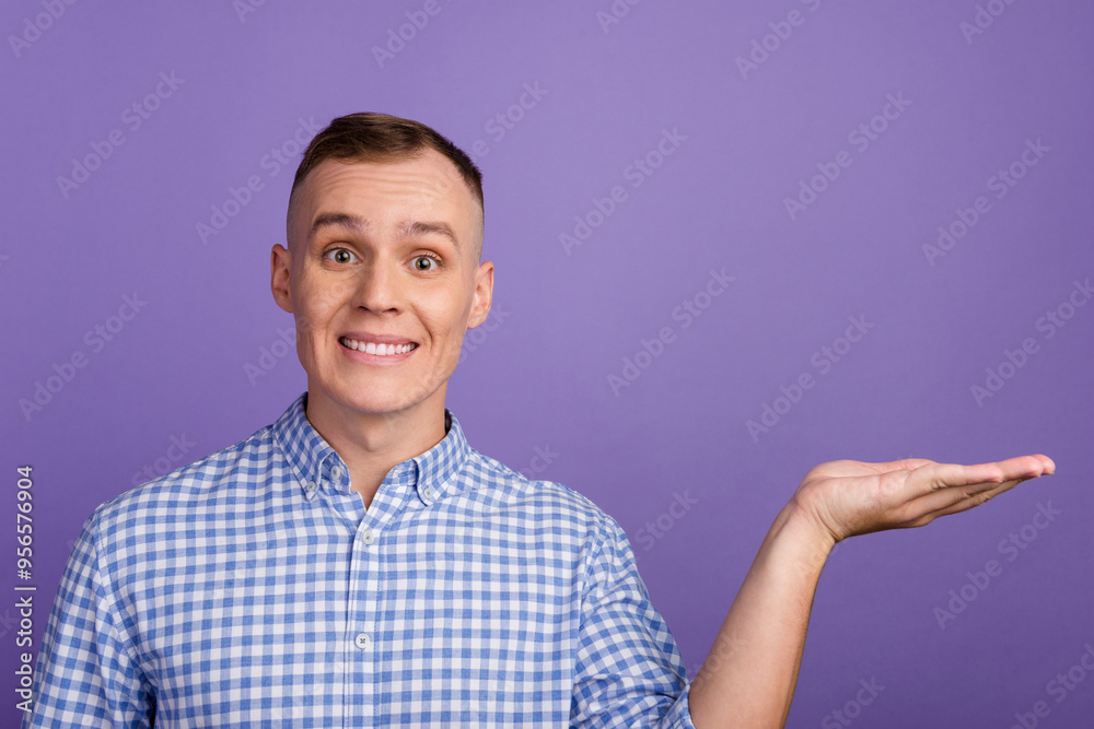 Photo of young businessman promoting new product hold open palm arm hand isolated purple background