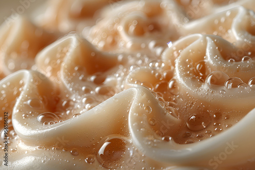 a close-up of a dessert or ice cream. The ice cream appears to be a light brown color and has a smooth texture. It is swirled in a wavy pattern, creating a wave-like effect. 