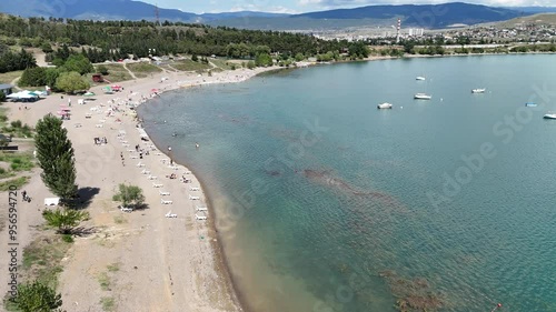 Aerial view of people relaxing on the beach. Sunbathing on the seashore. Tbilisi Sea. Travel in Georgia.