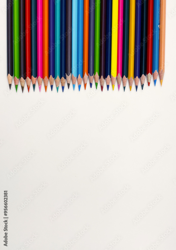 Colorful sharpened pencils are lined up on the table.