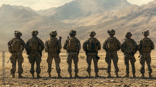 back view of group of soldier in desert area with mountain for military operation during war . Concept of army surveillance intelligence warfare technology