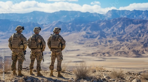 back view of group of soldier in desert area with mountain for military operation during war . Concept of army surveillance intelligence warfare technology