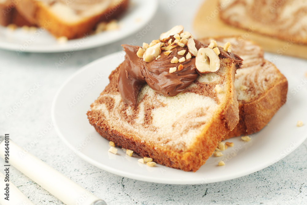 A piece of marble biscuit with chocolate cream and nuts