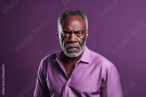 Lavender background sad black American independent powerful man. Portrait of older mid-aged person beautiful bad mood expression isolated 