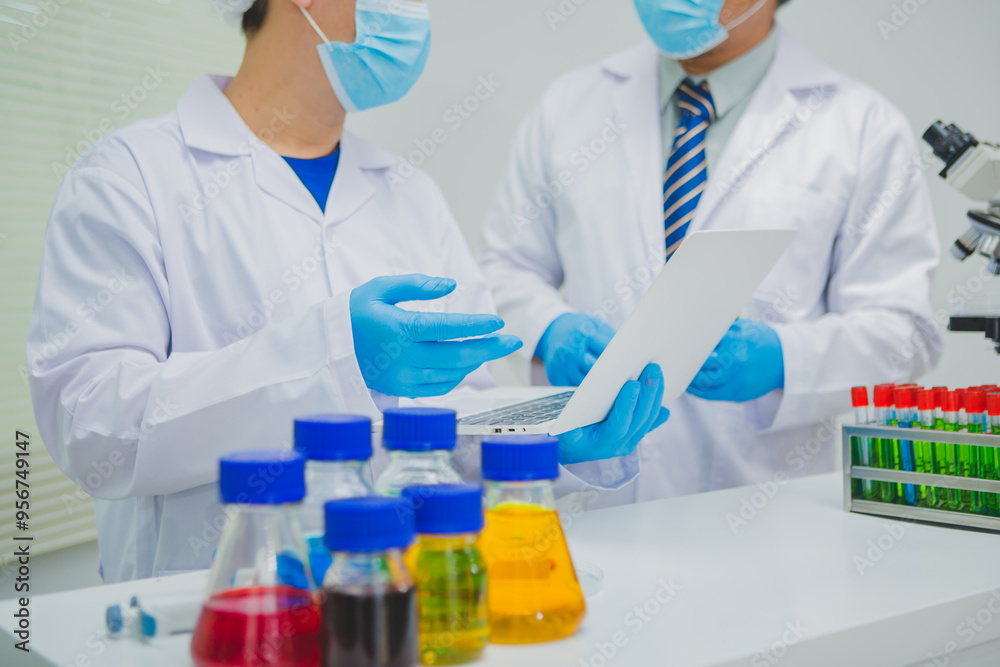 In this chemical experiment, two researchers collaborate to mix reactants, carefully observe changes such as color shifts or gas production, and analyze results, demonstrating principles of chemistry In this chemical experiment, two researchers collaborate to mix reactants, carefully observe changes such as color shifts or gas production, and analyze results, demonstrating principles of chemistry