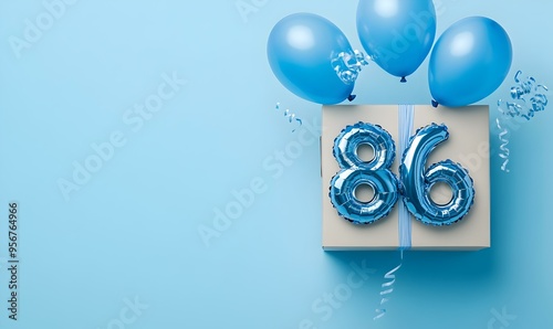 Happy birthday 86th with blue foil balloons and gift box on color background photo