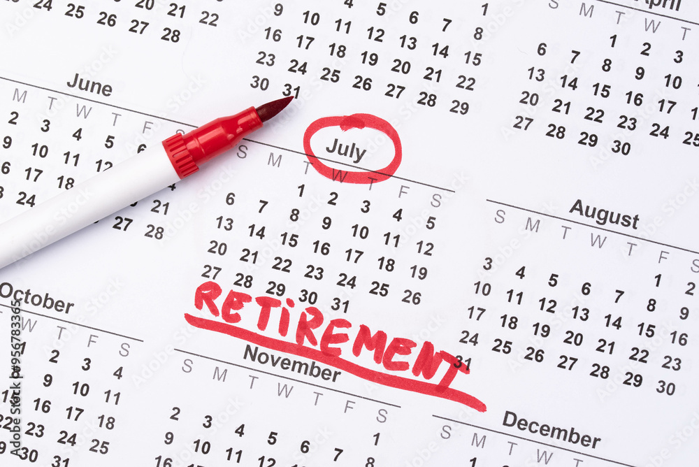 Hand fills in a large wall calendar, counting down the days until retirement, writing 'Retirement'. Concept of early retirement, the Financial Independence, Retire Early movement (FIRE) Hand fills in a large wall calendar, counting down the days until retirement, writing 'Retirement'. Concept of early retirement, the Financial Independence, Retire Early movement (FIRE)