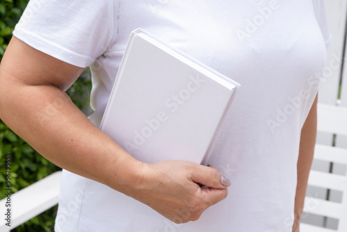 unrecognizable woman holding blank book for mockup design