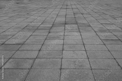 Empty grey tiled floor, pavement in perspective on modern architecture background. Abstract concrete glass building, Outdoor observation deck. street urban tile flooring. paving stones. blurred city.