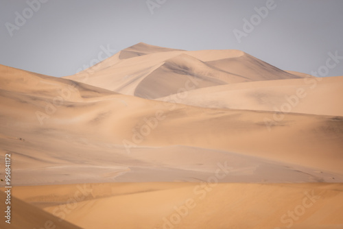 Soft shades of yellow, orange and brown, that look like a painting, on the sand dunes of the Namib Desert near Swakopmund, Namibia photo