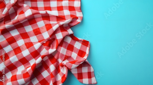 Red and White Checkered Tablecloth Corner on a Blue Background