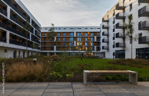Modern living building with park, bench and trees. Downtown czech real estate, housing background