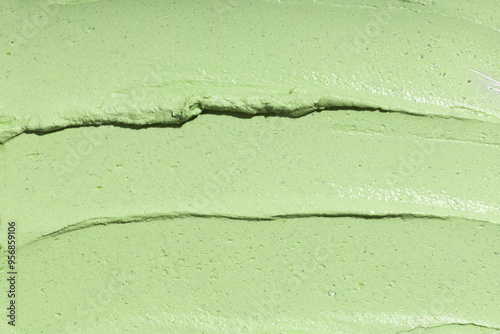 Swatch texture of green cream cray kaolin cosmetic mask for face and body, background. Copy space