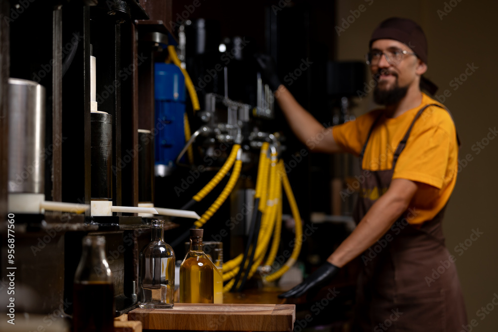 Worker pours sunflower to press on local production. Fresh extra virgin organic oil, healthy eco product Worker pours sunflower to press on local production. Fresh extra virgin organic oil, healthy eco product