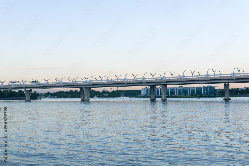 Evening cityscape with automobile bridge over river Evening cityscape with automobile bridge over river