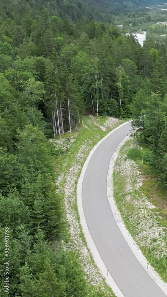 scenic road in forest next to mountain valley stream river water sand rocks cyclists aerial footage tourism travel holiday scenic road in forest next to mountain valley stream river water sand rocks cyclists aerial footage tourism travel holiday