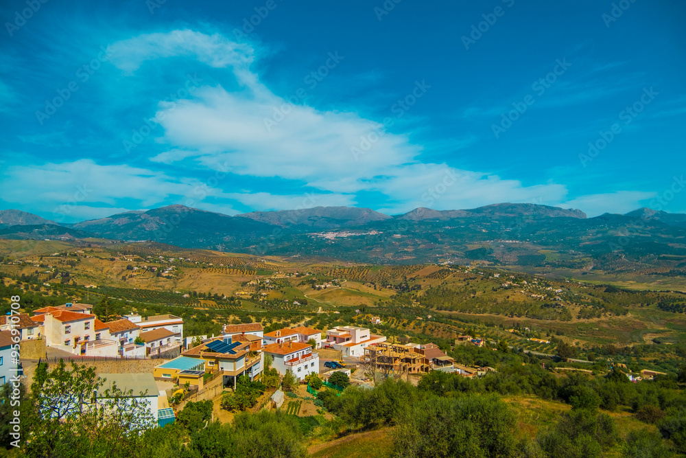 Fototapeta premium Beautiful view of a Spanish village in the interior of Andalucia with mountains in the background