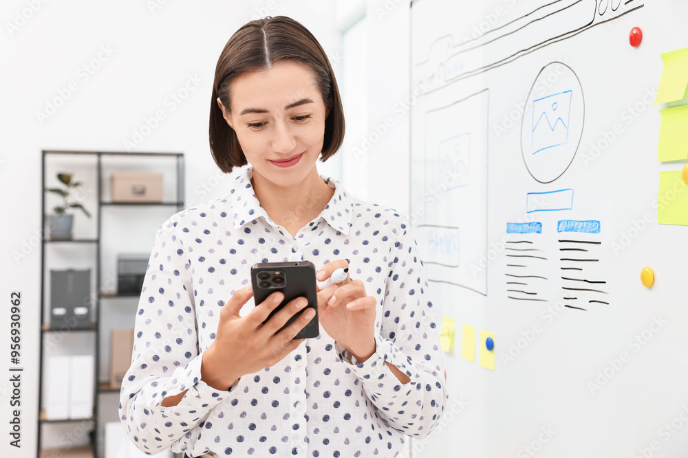 Developing UI design. Woman drawing website wireframe on whiteboard indoors Developing UI design. Woman drawing website wireframe on whiteboard indoors