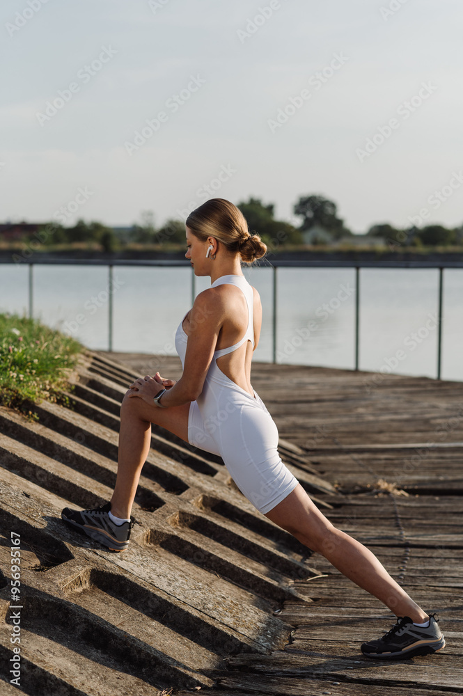 Cute sports fitness athlete woman is exercising or warming up in the morning in the park Cute sports fitness athlete woman is exercising or warming up in the morning in the park