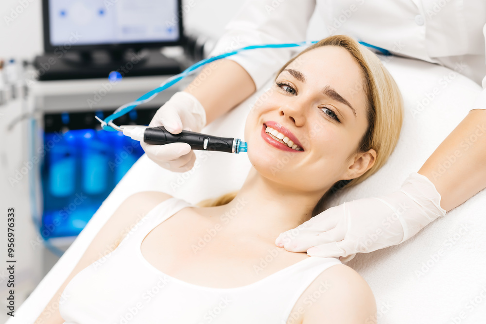 A professional performs a hydropeeling facial treatment on a woman in a modern clinic, focusing on deep skin cleansing and rejuvenation. Perfect for showcasing advanced skincare techniques. A professional performs a hydropeeling facial treatment on a woman in a modern clinic, focusing on deep skin cleansing and rejuvenation. Perfect for showcasing advanced skincare techniques.