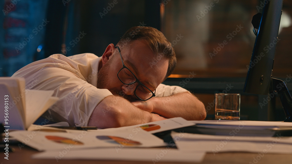 Tired fatigued exhausted Caucasian businessman employer sleeping at table on papers sleep insomnia health problem chronic exhaustion late time deadline napping guy business man male at night office Tired fatigued exhausted Caucasian businessman employer sleeping at table on papers sleep insomnia health problem chronic exhaustion late time deadline napping guy business man male at night office