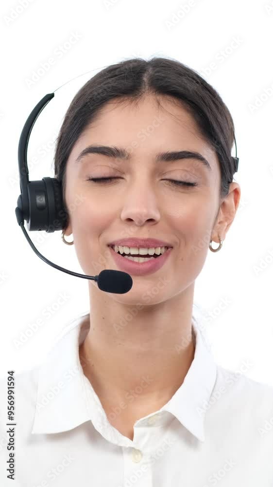 Portrait of a happy female Caucasian contact centre operator engaged in communication with customer or client on white background. Vertical video. Portrait of a happy female Caucasian contact centre operator engaged in communication with customer or client on white background. Vertical video.