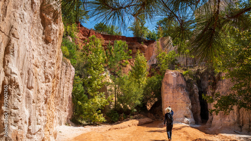 A man is enjoying the spectacular view of Providence Cayon Park, a manmade canyon, mimic of the Grand Canyon. It spans approximately 1,003 acres and features dramatic canyons with vibrant colors creat photo