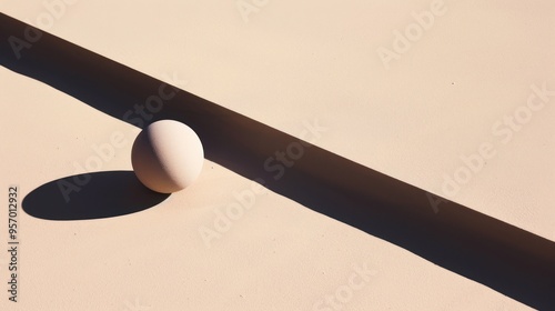 White Sphere and Shadow on a Beige Surface