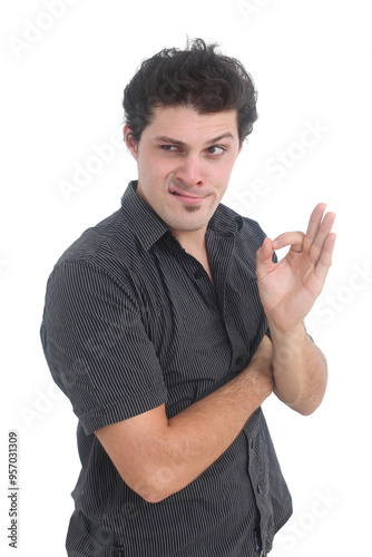 Photos portrait of a young overconfident man showing  ok hand gesture with evil smile o