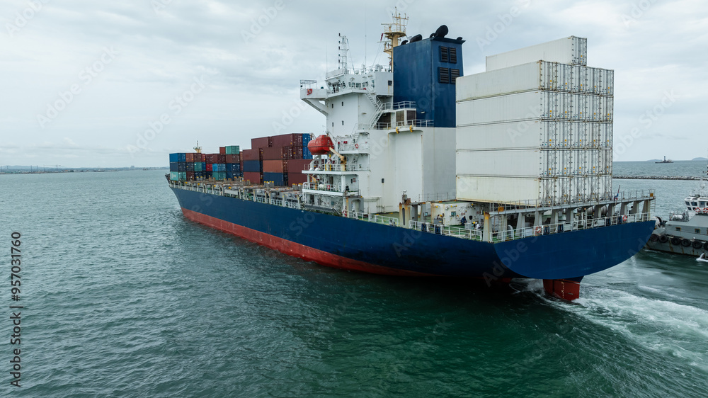 Fototapeta premium logistic cargo container ship sailing in sea to import export goods and distributing products to dealer and consumers across worldwide, by container ship Transport business.