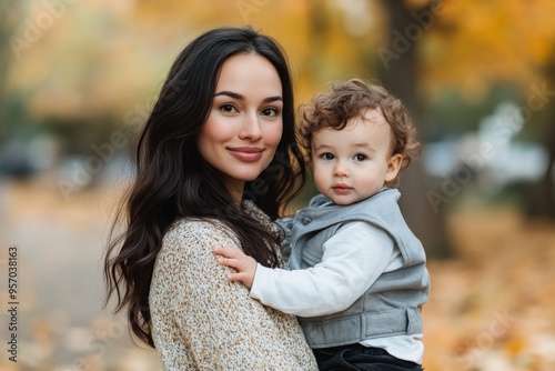 A mom and son walk in an autumn park, having fun together.