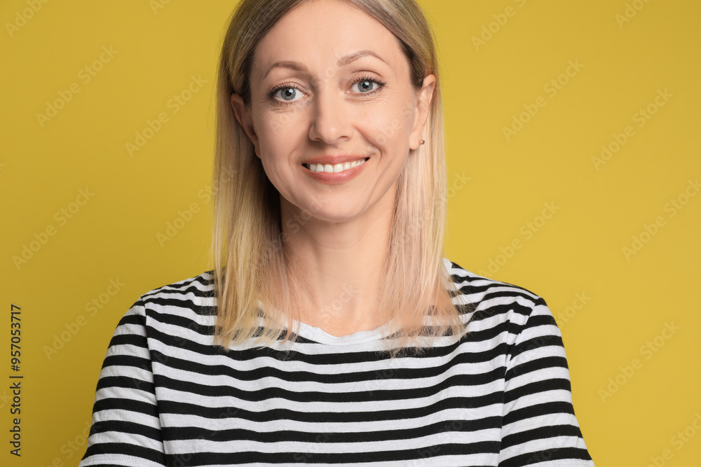 Portrait of beautiful smiling woman on yellow background Portrait of beautiful smiling woman on yellow background
