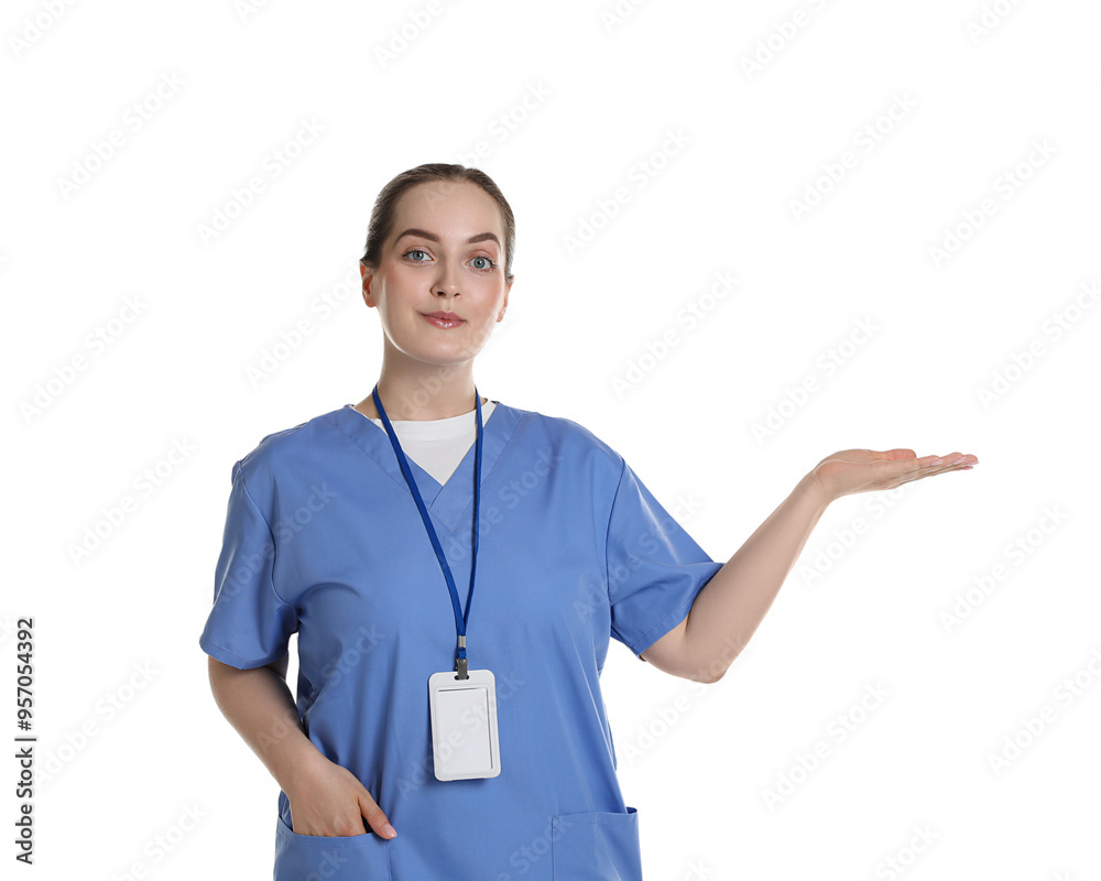 Professional nurse with badge pointing at something on white background Professional nurse with badge pointing at something on white background