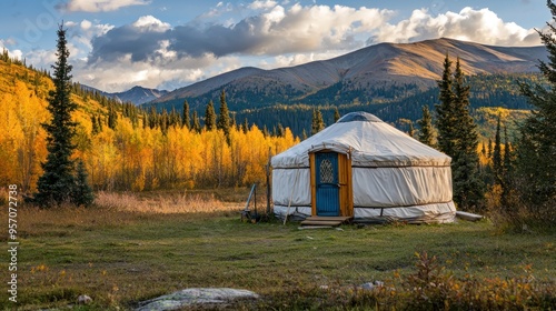 A yurt camping site during the day, with the yurt set against a backdrop of mountains or forest. photo