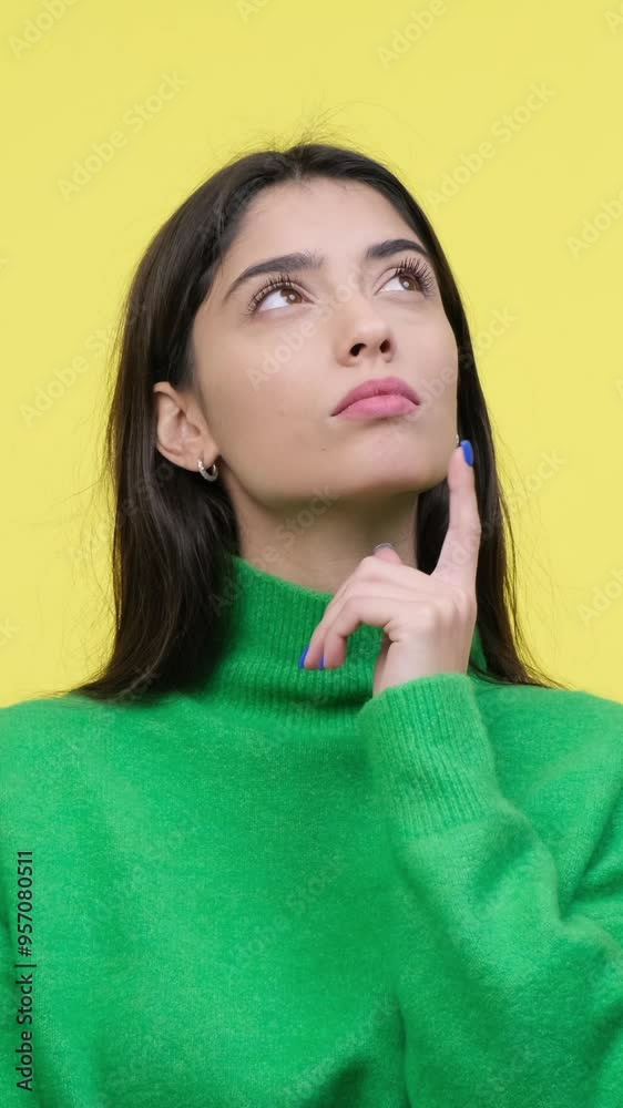 Thoughtful woman contemplating and brainstorming on yellow background. Concept of a planning, making decision or choice. Vertical video. Thoughtful woman contemplating and brainstorming on yellow background. Concept of a planning, making decision or choice. Vertical video.