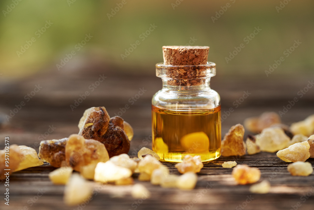 A bottle of aromatherapy essential oil with frankincense resin, outdoors A bottle of aromatherapy essential oil with frankincense resin, outdoors