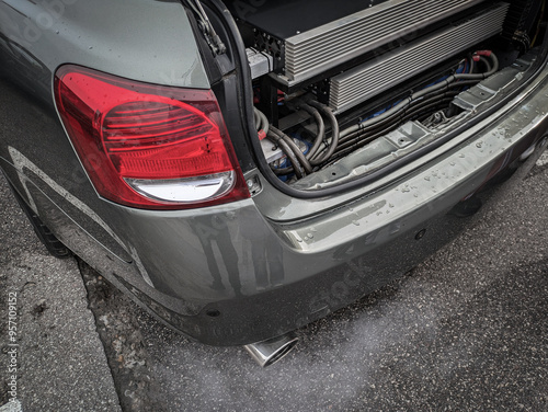 Sedan car with open trunk. In the trunk there are amplifiers for speakers, sound. For loud music and bass. photo